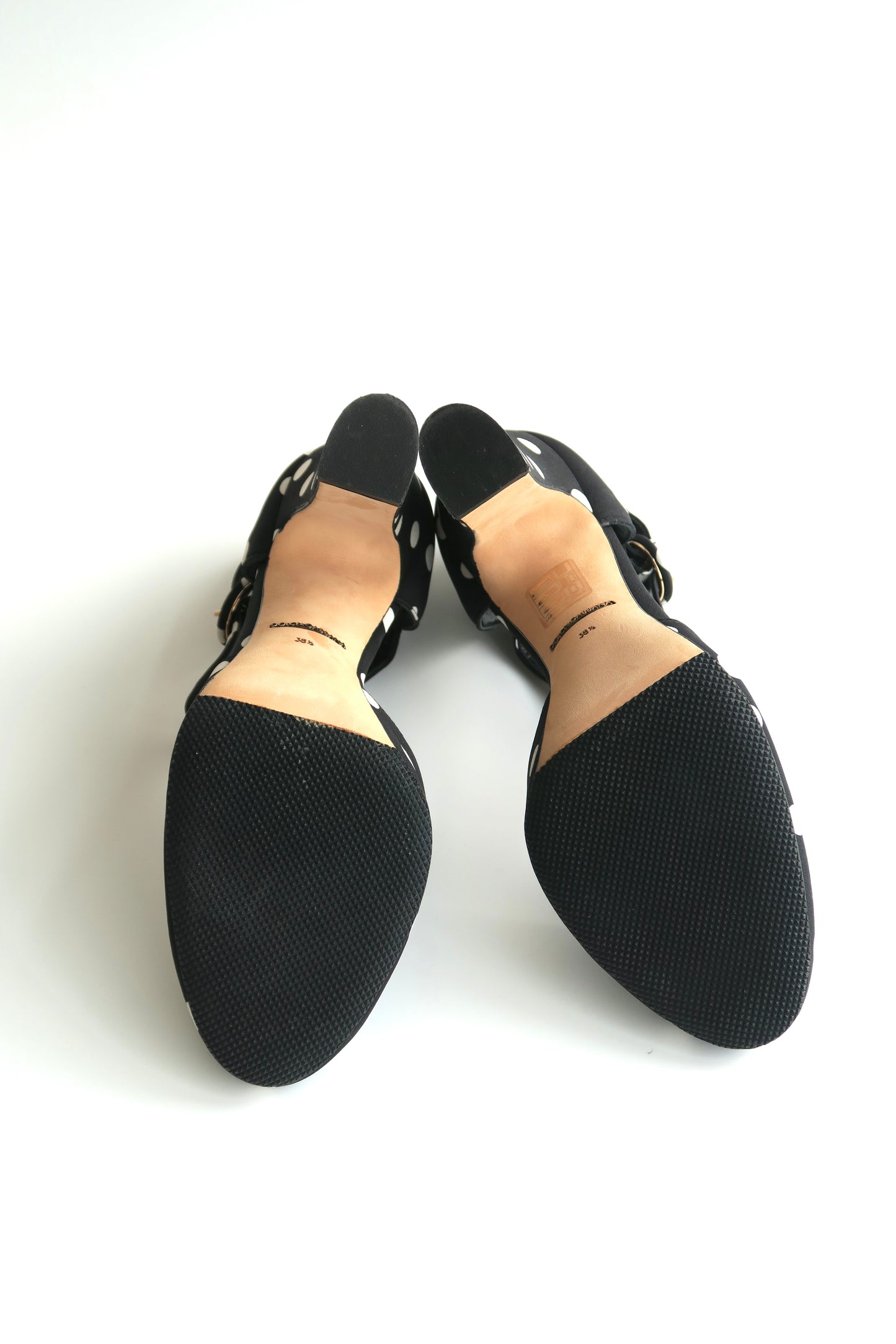 Pair of black round-toe shoes showing outsoles on a white background