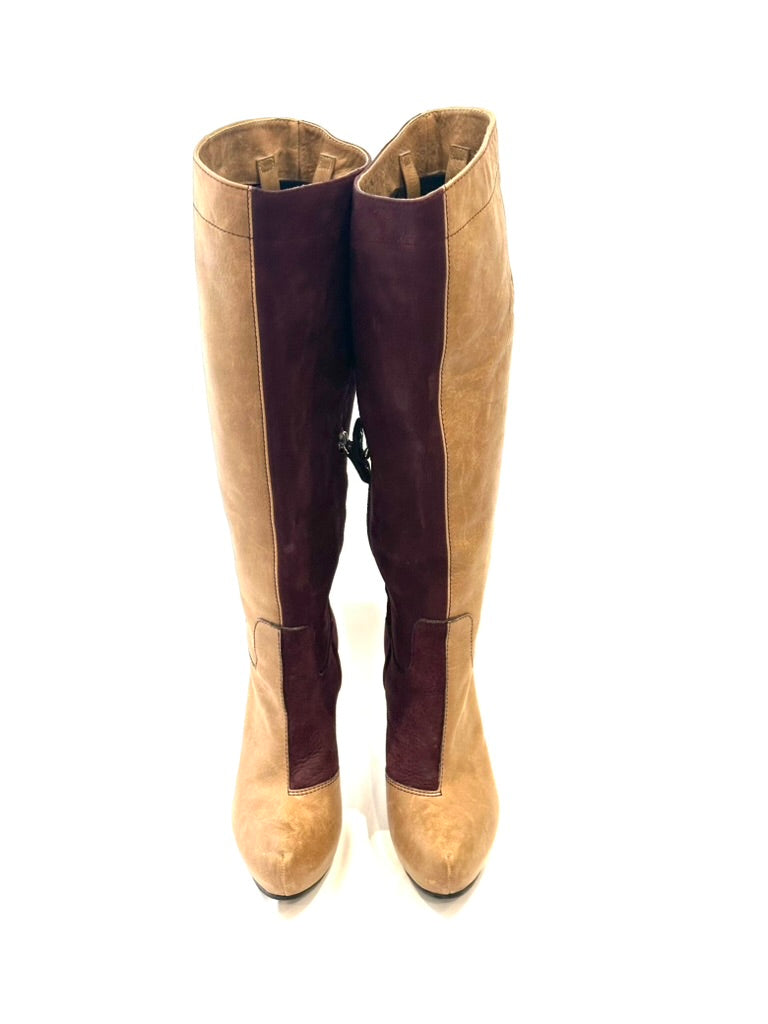 Tan knee-high boots with brown accents on a white background