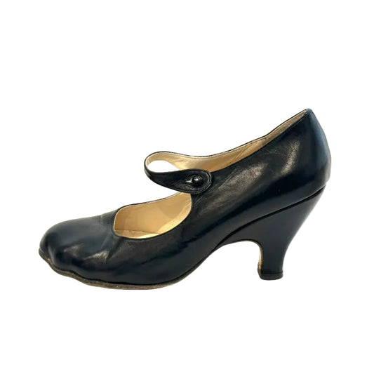 Black shoe with a small heel on a white background