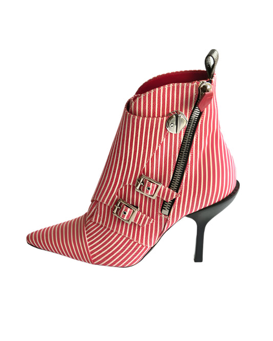 Red and white striped ankle boot with buckles and a zipper on a light white background