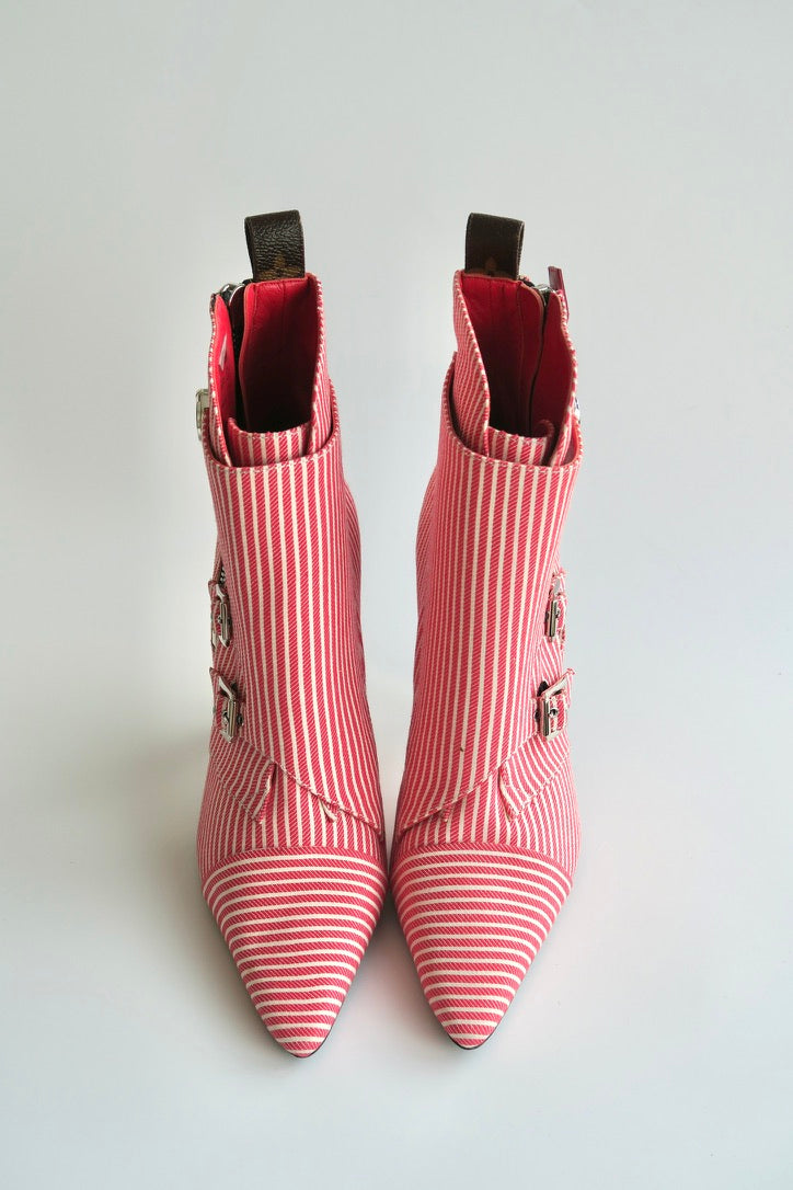Red and white striped ankle boots on a light gray background