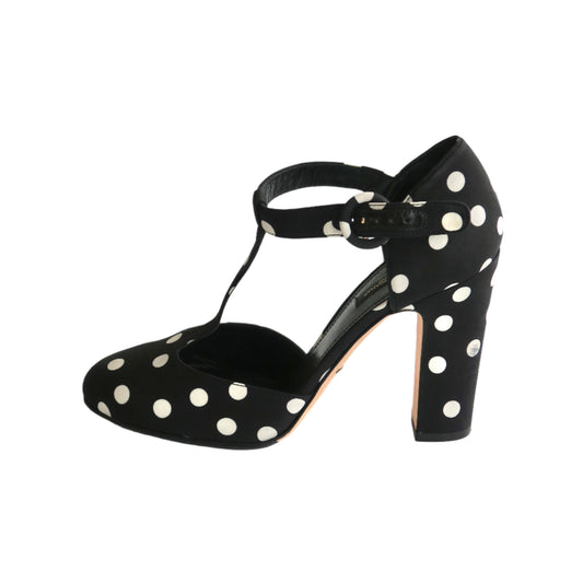 Black shoe with white polka dots on a white background