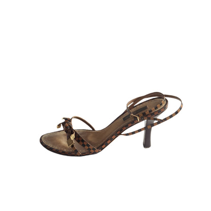 Brown sandal with thin straps on a white background