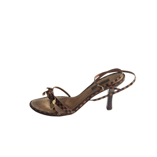Brown sandal with thin straps on a white background